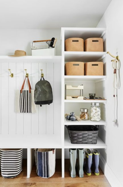 Organized mudroom with hooks, baskets and shelves